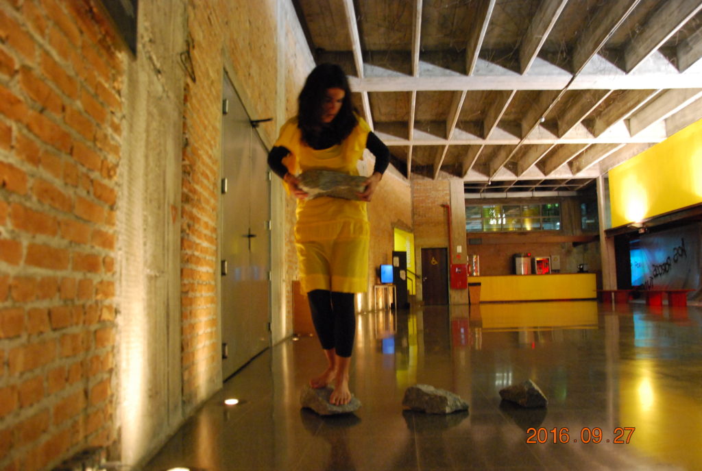 Tentativa#2. Performance duracional. Ações movidas: carregar as pedras, andando nelas. Tricotar com olhos fechados.  Ação realizada no TUCARENA, SP, Brasil, durante a Semana das Artes do Corpo (2017). Foto: Bianca Hisse
